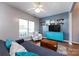Living room with hardwood floors, custom shelving, and ample natural light offering a blend of style and comfort at 12328 Jessica Pl, Charlotte, NC 28269