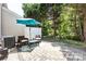 Charming patio area with umbrella, seating, and views of the well-manicured backyard at 12328 Jessica Pl, Charlotte, NC 28269