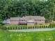 Aerial view of the home's backyard featuring mature trees, landscaping, and green space at 12705 Caldwell Rd, Charlotte, NC 28213