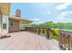 A backyard deck with wood railing overlooking a yard with green trees and partially cleared area at 12705 Caldwell Rd, Charlotte, NC 28213