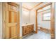 A bathroom with modern wood-look floors, a wood vanity, decorative lighting, and a toilet at 12705 Caldwell Rd, Charlotte, NC 28213