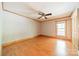 Empty bedroom with window, wood floors, ceiling fan, and closet at 12705 Caldwell Rd, Charlotte, NC 28213