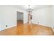 Open-concept dining room with hardwood floors, a chandelier, and easy access to other living spaces at 12705 Caldwell Rd, Charlotte, NC 28213