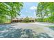 Sprawling single-story brick home with a long driveway and a beautifully landscaped yard at 12705 Caldwell Rd, Charlotte, NC 28213