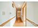 Long hallway with wood floors, white walls, and wood trim detailing at 12705 Caldwell Rd, Charlotte, NC 28213