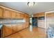 Well-lit kitchen with wooden cabinetry, tile backsplash, and stainless steel appliances at 12705 Caldwell Rd, Charlotte, NC 28213