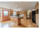 Bright kitchen featuring wooden cabinets, tile backsplash, island, and stainless steel appliances at 12705 Caldwell Rd, Charlotte, NC 28213