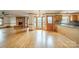 Open concept floorplan featuring hardwood floors, brick fireplace, and a bright sunny kitchen at 12705 Caldwell Rd, Charlotte, NC 28213