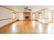 Bright living room with hardwood floors, brick fireplace, and natural light at 12705 Caldwell Rd, Charlotte, NC 28213