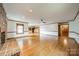 Open living room with hardwood floors, brick fireplace, and plenty of natural light at 12705 Caldwell Rd, Charlotte, NC 28213