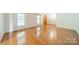 Bright living room with gleaming hardwood floors and large windows filling the space with natural light at 12705 Caldwell Rd, Charlotte, NC 28213