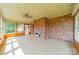 Spacious enclosed sunroom features brick wall, tile floor, and plenty of light at 12705 Caldwell Rd, Charlotte, NC 28213