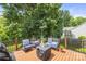 Relaxing outdoor deck area with comfortable seating, shade, and lush green surroundings at 128 Sugar Thyme Ln, Mooresville, NC 28115