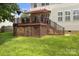 A two level backyard deck with stairs leading to a green, well-maintained lawn at 128 Sugar Thyme Ln, Mooresville, NC 28115