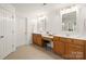 Dual sinks and vanities in a bathroom with a door leading to another room at 128 Sugar Thyme Ln, Mooresville, NC 28115