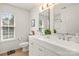 Bright bathroom with double vanity, planked wall, and a window providing natural light at 128 Sugar Thyme Ln, Mooresville, NC 28115