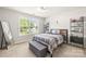 Comfortable bedroom featuring a striking brick accent wall and ample natural light at 128 Sugar Thyme Ln, Mooresville, NC 28115
