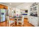 Cozy dining area adjacent to the kitchen, featuring a round table and hardwood floors at 128 Sugar Thyme Ln, Mooresville, NC 28115
