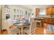 Bright dining area with a round table, plantation shutters, and views of the kitchen at 128 Sugar Thyme Ln, Mooresville, NC 28115