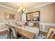 Elegant dining room featuring a stylish chandelier, a large mirror, and a beautifully set dining table at 128 Sugar Thyme Ln, Mooresville, NC 28115