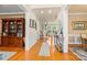 Spacious foyer with hardwood floors, wainscoting and view of the living spaces beyond at 128 Sugar Thyme Ln, Mooresville, NC 28115