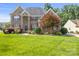 Charming brick home with manicured lawn, colorful landscaping, and lovely curb appeal in a desirable neighborhood at 128 Sugar Thyme Ln, Mooresville, NC 28115