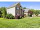 Well-maintained brick home with a vibrant lawn and mature landscaping, showcasing curb appeal at 128 Sugar Thyme Ln, Mooresville, NC 28115