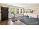 Home gym equipped with fitness machines, rubber flooring, and a full wall mirror at 128 Sugar Thyme Ln, Mooresville, NC 28115