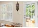 Kitchen area with white door to the exterior deck with lots of natural light from the plantation shutters at 128 Sugar Thyme Ln, Mooresville, NC 28115
