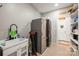 Laundry room features modern washer/dryer, stainless steel refrigerator, sink and plenty of storage at 128 Sugar Thyme Ln, Mooresville, NC 28115