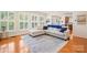Open-concept living room with hardwood floors, plantation shutters, and lots of natural light at 128 Sugar Thyme Ln, Mooresville, NC 28115
