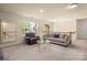 Cozy loft area featuring plush seating and a window for natural light at 128 Sugar Thyme Ln, Mooresville, NC 28115