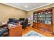 Well-appointed office with wooden desk, bookcase and comfortable workspace at 128 Sugar Thyme Ln, Mooresville, NC 28115