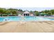 Community swimming pool and amenities featuring ample seating for enjoying the summer sun at 128 Sugar Thyme Ln, Mooresville, NC 28115