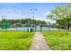 Community tennis courts, featuring a fenced in area and gated entrance at 128 Sugar Thyme Ln, Mooresville, NC 28115