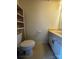 Modest half bathroom featuring a toilet, sink, and a wicker storage unit at 1300 Larchmont Pl, Salisbury, NC 28144