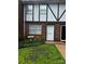 Charming brick townhome with well-maintained lawn and white-trimmed windows near the front door at 1300 Larchmont Pl, Salisbury, NC 28144