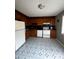Functional kitchen with wooden cabinets, white appliances, and a unique patterned floor at 1300 Larchmont Pl, Salisbury, NC 28144
