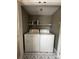 Practical laundry room equipped with a washer, dryer, and storage shelf at 1300 Larchmont Pl, Salisbury, NC 28144