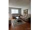 Cozy living room featuring comfortable seating, a stylish rug, and warm wood floors at 1300 Larchmont Pl, Salisbury, NC 28144