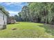 Expansive backyard featuring a screened porch, storage shed, and mature trees, perfect for outdoor activities and relaxation at 1310 Glasscock Rd, Rock Hill, SC 29730
