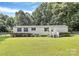 Charming single-story home featuring a well-manicured lawn, classic white siding, and dark shutters at 1310 Glasscock Rd, Rock Hill, SC 29730