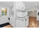Convenient laundry area with modern white washer, dryer, and adjacent microwave and cabinets at 1310 Glasscock Rd, Rock Hill, SC 29730