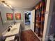 Bathroom with double sinks, decor, and a view to a bedroom at 13211 Asbury Chapel Rd, Huntersville, NC 28078