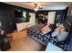 Bedroom showcasing a large bed, hardwood flooring, ceiling fan, and a modern entertainment center at 13211 Asbury Chapel Rd, Huntersville, NC 28078