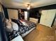 Primary bedroom with a large bed, black accent wall, ceiling fan, and ample closet space at 13211 Asbury Chapel Rd, Huntersville, NC 28078