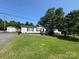 Charming single-story home featuring a spacious front yard and a detached garage at 13211 Asbury Chapel Rd, Huntersville, NC 28078