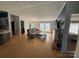 Inviting living room with hardwood floors, a cozy couch, and modern entertainment center at 13211 Asbury Chapel Rd, Huntersville, NC 28078
