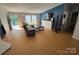 Cozy living room with a comfortable couch, entertainment center and natural light at 13211 Asbury Chapel Rd, Huntersville, NC 28078
