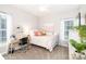 This bedroom features a full bed, desk space, and plenty of natural light from the window at 133 Upland Dr, Statesville, NC 28625